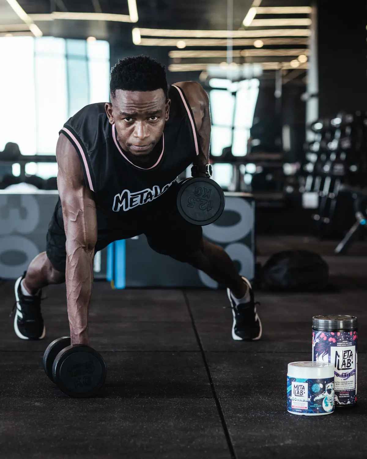 MetaLab athlete lifting a dumbbell from the floor