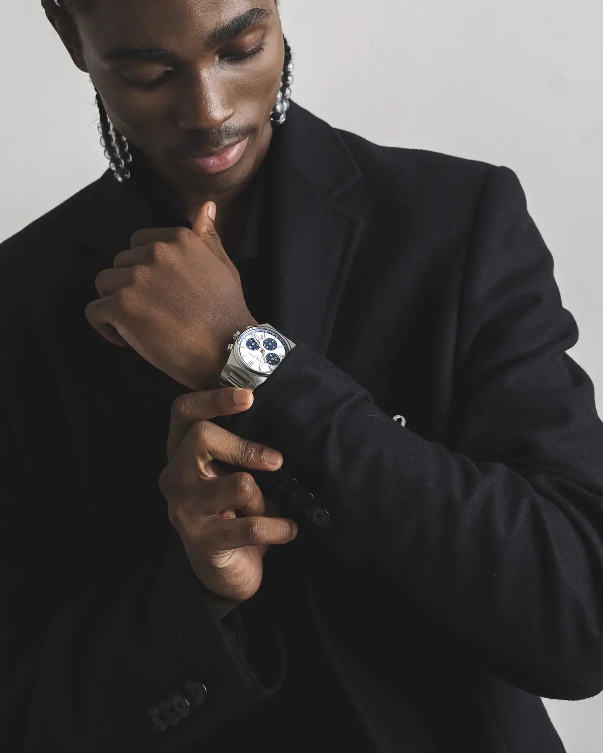 Luxity studio shot of a watch worn with a tailored suit