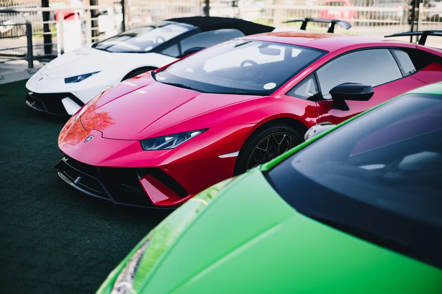 Row of Lamborghini Huracáns in pink, white and green