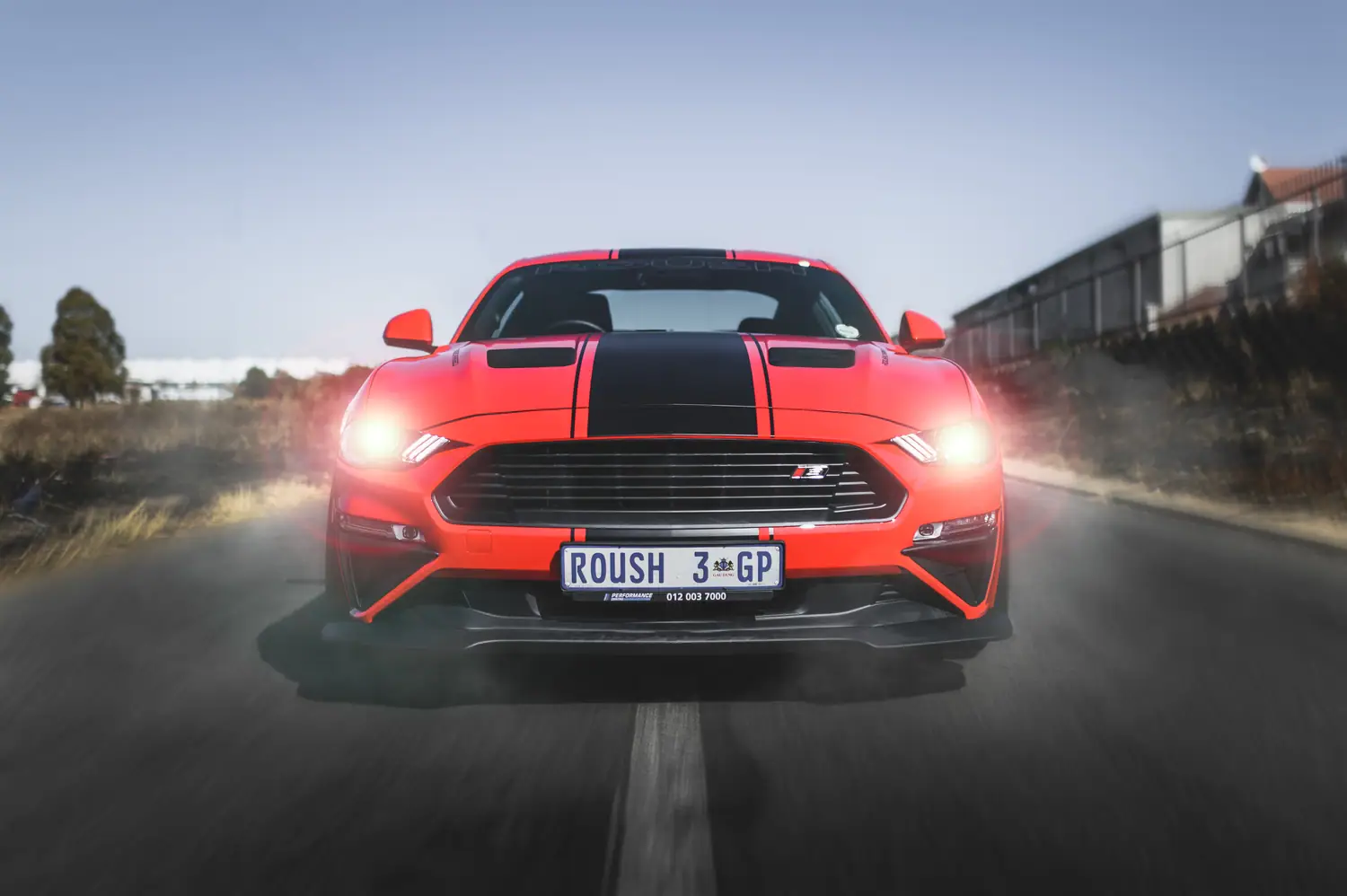 Roush Mustang at speed with headlights lit