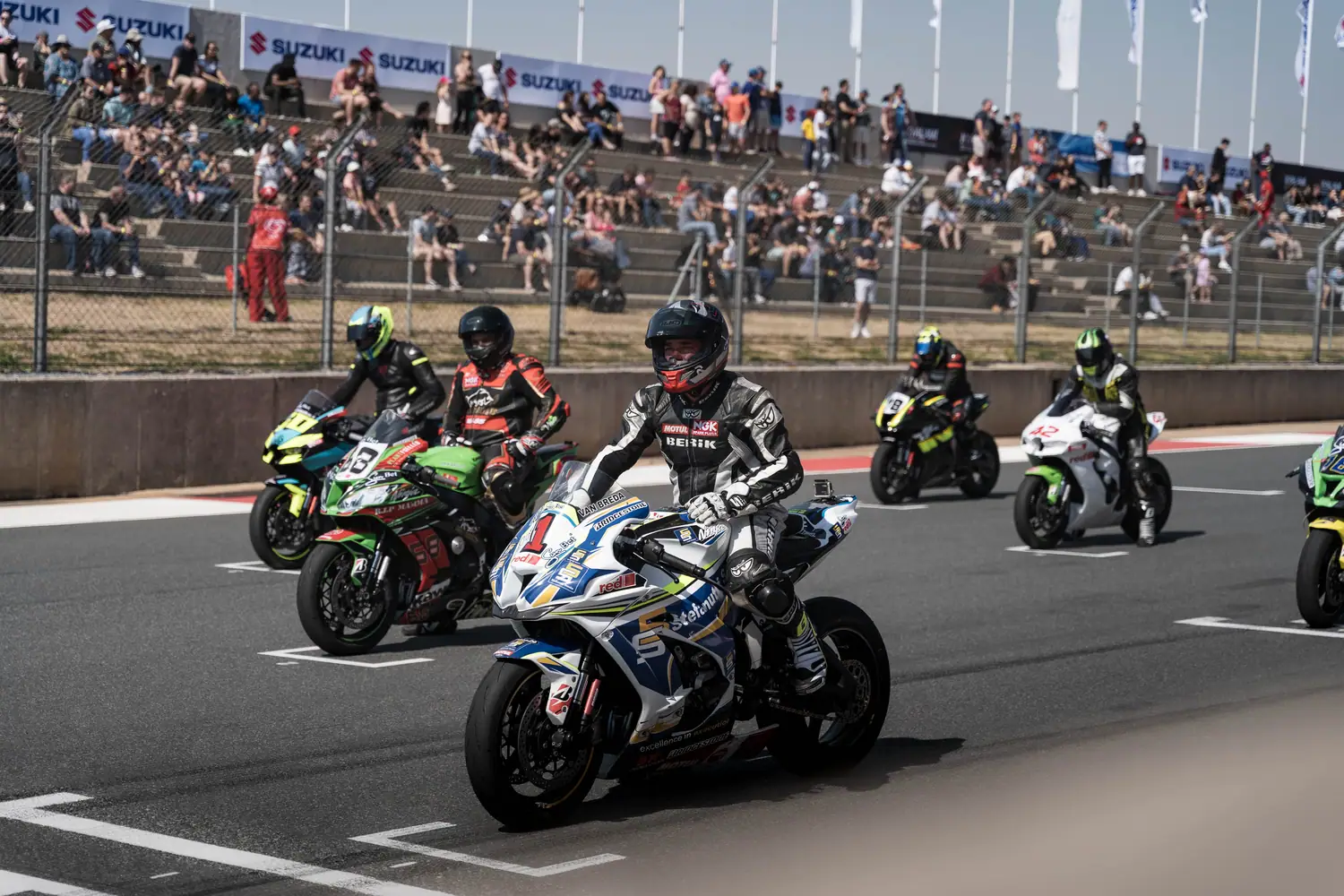 Superbike pack leaning into a corner at the Festival of Motoring